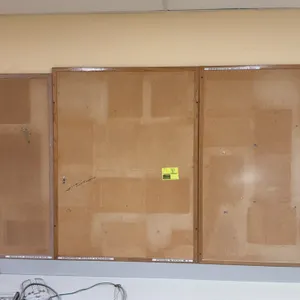 Assorted wall-mounted cork bulletin boards. Features cork tack surfaces with wood frames in assorted sizes and finishes. Wall-mounted design.