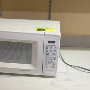 General Electric countertop microwave oven. Features digital touchpad controls, preset cooking options, and push-button door release. Electrical: 120V