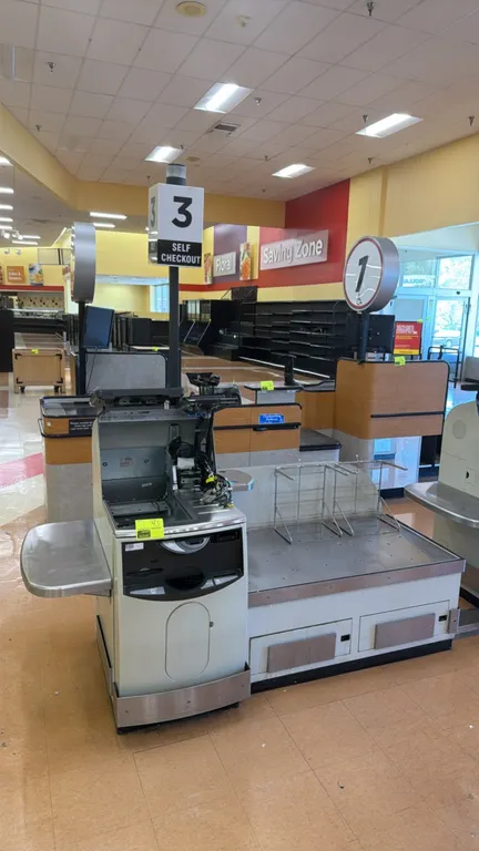 NCR 7350 self-checkout lane. Features stainless steel top bagging deck, touchscreen display, lane light pole, and (2) wire bag stands. 7'L. S/N: 30-48