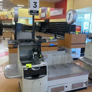 NCR 7350 self-checkout lane. Features stainless steel top bagging deck, touchscreen display, lane light pole, and (2) wire bag stands. 7'L. S/N: 30-48