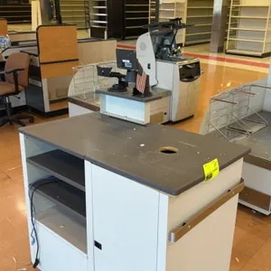 Laminate retail checkout counter. Features a gray laminate countertop with cable pass-through hole, raised upper shelf with POS mounting brackets, low
