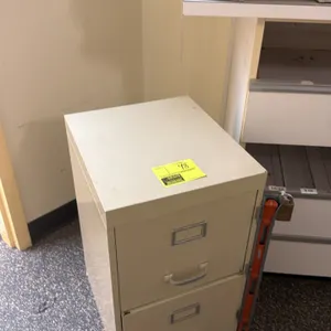 Metal 2-drawer vertical filing cabinet. Features pull handles, integrated label holders, and a side-mounted locking security bar with padlock.