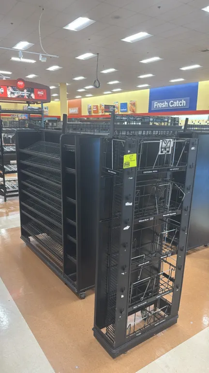Metal portable candy and magazine merchandiser sets. Features multi-tier wire display shelving, end cap wire magazine racks, pegboard back panels, and