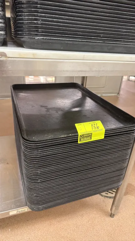 Poly trays. Features black polymer construction with raised edges. Dimensions: 26" x 18". Table not included.