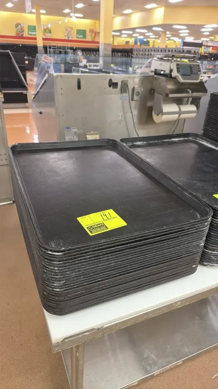 Poly display trays. Features black polyethylene construction with raised edges. Dimensions: 26" x 18".
