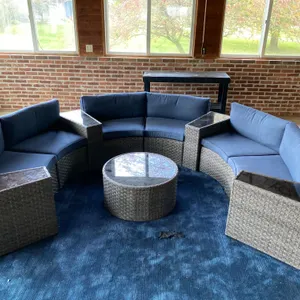 Outdoor Wicker Sectional Sofa With Round Glass Top Table and Blue Cushions
