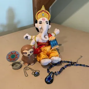 Items Including Plush Ganesha, Decorative Necklaces, Miniature Sloth Figurine, and Trinket Holder