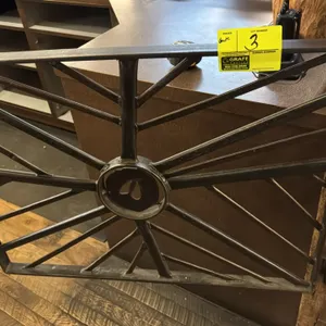 Decorative metal swing gate. Features welded steel construction with radiating spoke design, center medallion with hoof print cutout, and barrel hinge