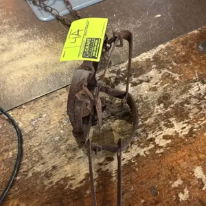 Vintage metal hunting foothold traps. Includes (1) double long spring trap and (1) single long spring trap, each equipped with an attached chain and r