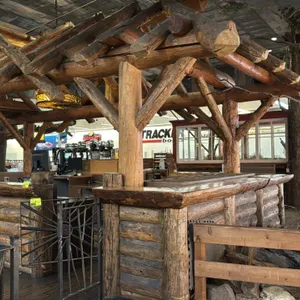 Rustic customer service counter. Features natural log timber pavilion canopy structure, half-log facade, and interior service counters with built-in s