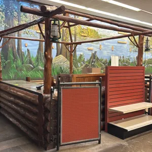 Rustic double checkout lane counter. Features log construction, overhead log canopy with hanging lantern lamps, metal-trimmed countertops, under-count