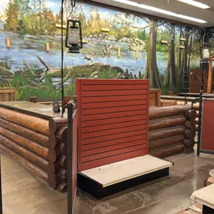 Rustic double checkout lane counter. Features log-style exterior siding, metal-trimmed countertops, integrated under-counter storage shelving, cabinet