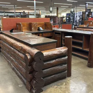 Rustic double checkout lane counter. Features log construction facade, metal-banded countertops, open under-counter storage shelving, cabinetry, and o