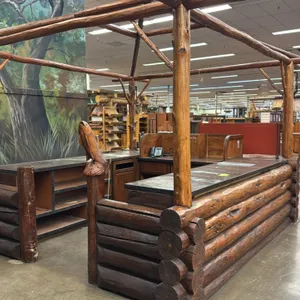 Rustic double checkout lane. Features log timber construction with overhead canopy arbor, hanging lantern lamps, carved fish post finial, metal-edge c