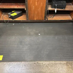 Anti-fatigue floor mats. Features black cushioned construction with ribbed and textured traction surface designs. 5' x 3'. Cabinetry, electronics, and