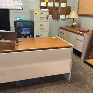 Office desk suite. Includes a 60" x 30" metal desk with woodgrain laminate top, double pedestals, and center pencil drawer; a 60" x 25" metal credenza