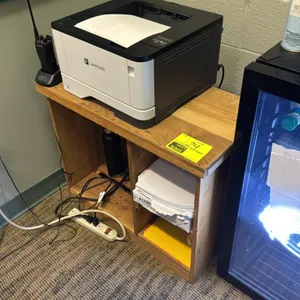 Wood printer stand. Features open lower storage compartments with divider shelf. 28" x 14" x 23". Printer, electronics, and contents not included.