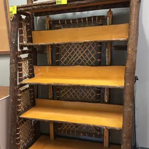 Rustic 4-tier wooden display shelf. Features natural bark-on log construction, woven rawhide-style lattice side and back panels, wooden shelves with r