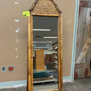 Freestanding wooden floor mirror. Features faux bamboo trim, arched woven rattan crest, front cabriole legs, and folding rear easel support. Dimension