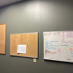 Assorted cork bulletin boards and dry erase whiteboard. Includes (1) wood-framed cork board, (1) aluminum-framed cork board, and (1) aluminum-framed d
