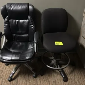Assorted office chairs. Includes (1) high-back black faux leather executive chair with padded armrests and (1) armless black upholstered drafting stoo