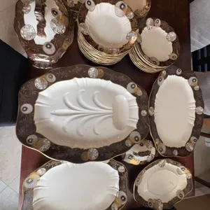 This is a 64-piece Doultons Willow & Aster dinnerware set featuring brown borders, gold gilt, and As