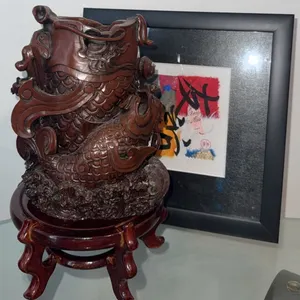 Carved Wood Vessel with Dragon Motif on Wooden Stand and Framed Artwork
