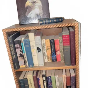 Bookshelf With Assorted Hardcover and Paperback Books, Including Our Magnificent Wildlife